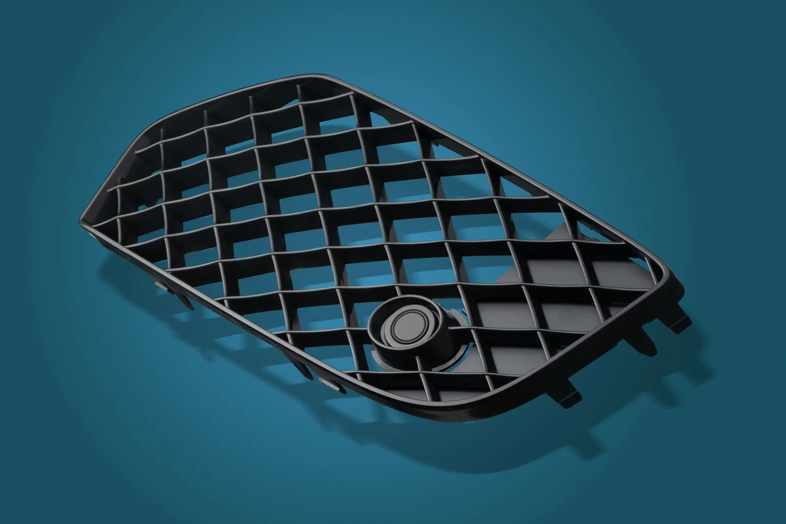 Black triangular moulded plastic grille photographed on a blue studio background
