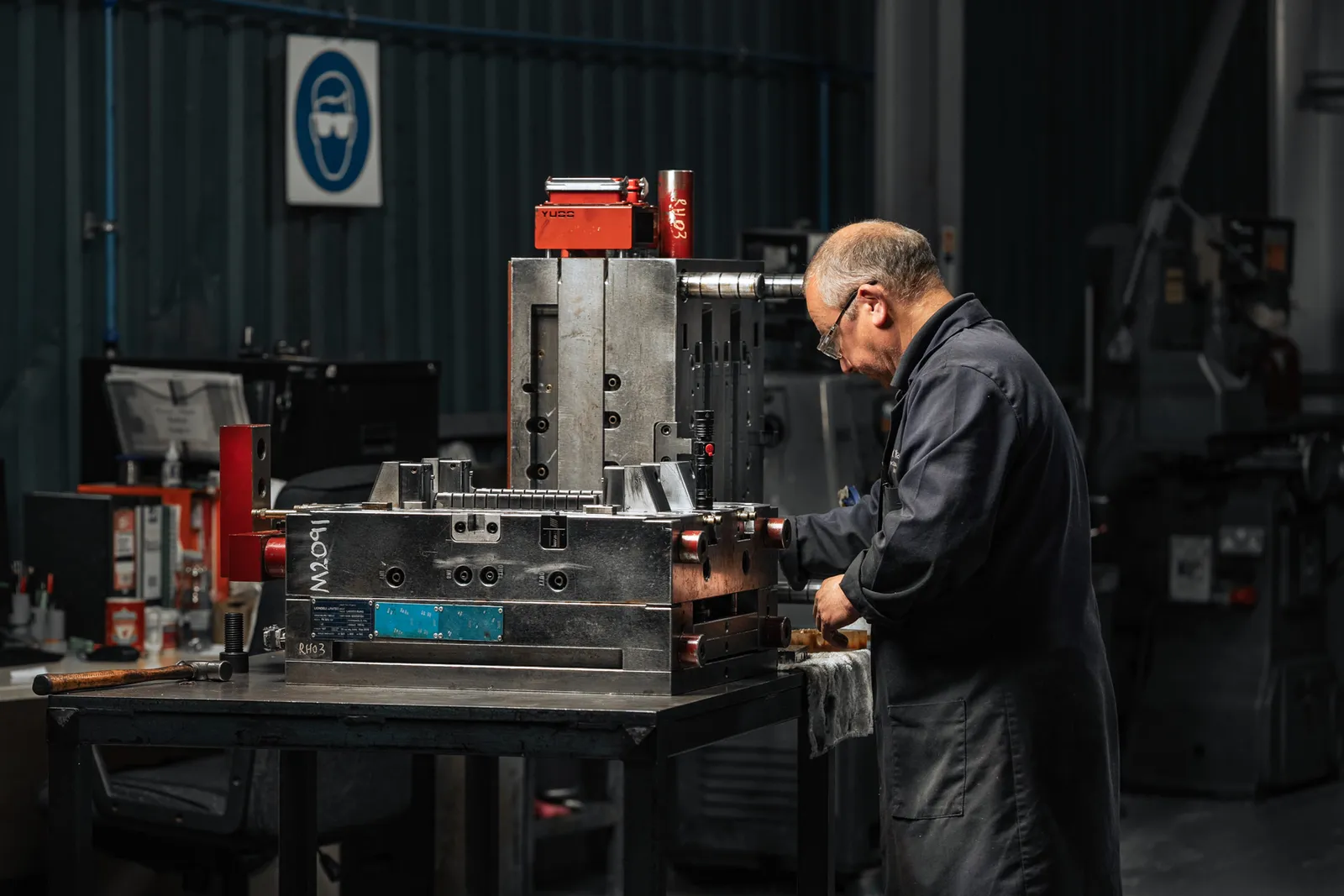 AC Plastics toolmaker working beside a large metal mould tool