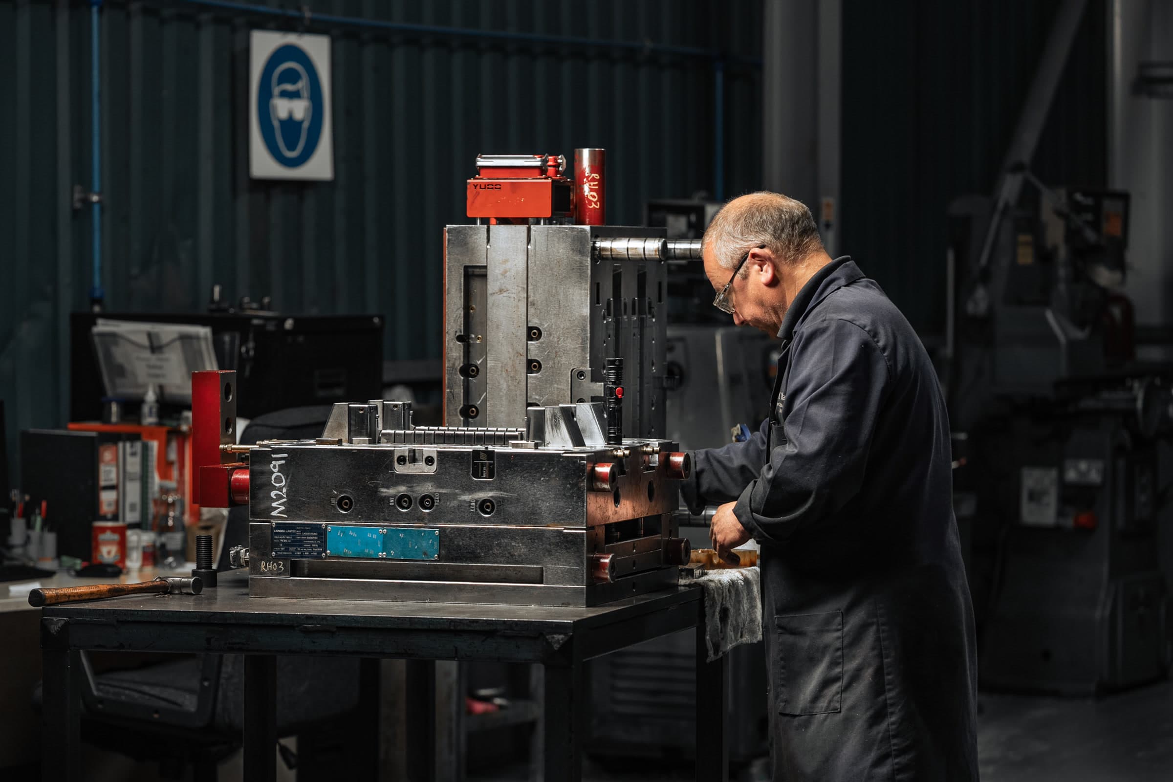 AC Plastics toolmaker working beside a large metal mould tool