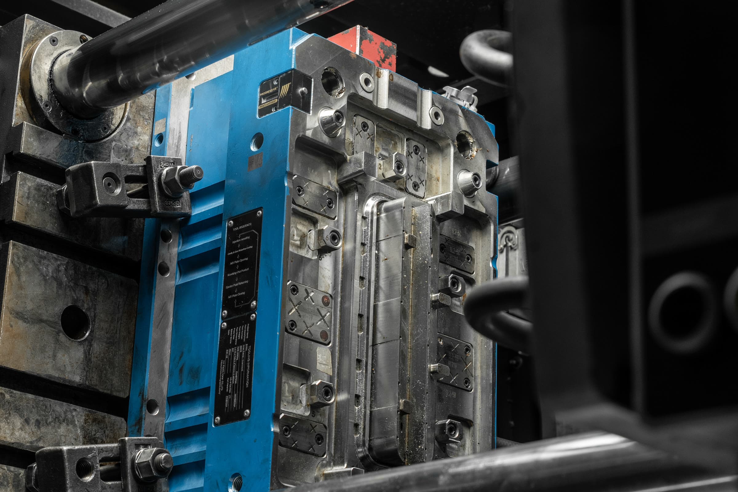 Blue-framed injection mould tool installed in production machinery