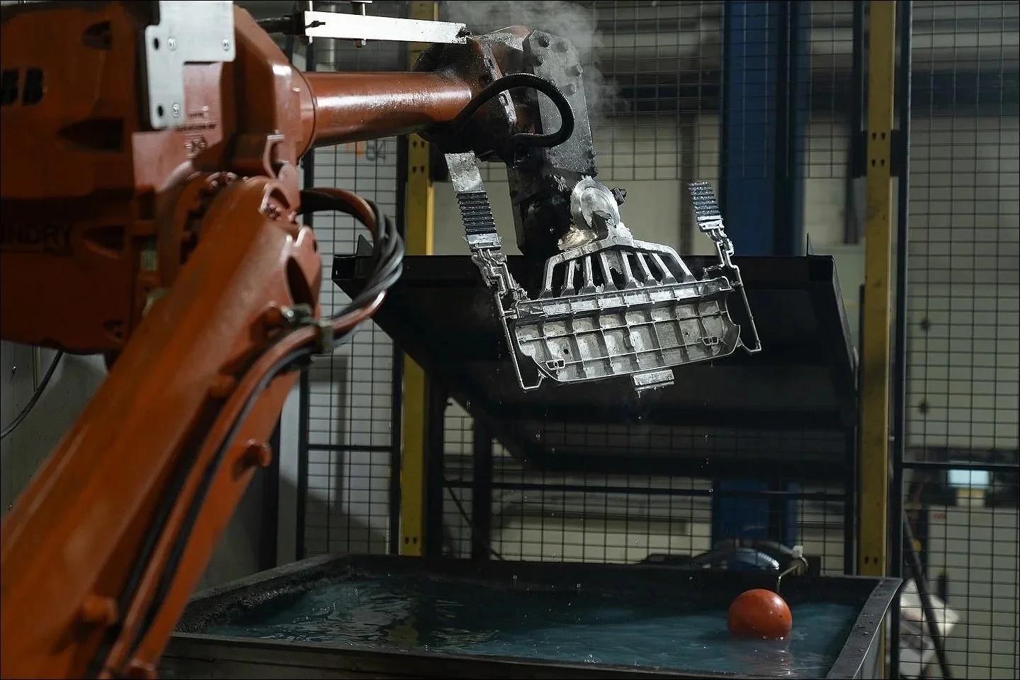 Robot arm extracting steaming die casting accrington