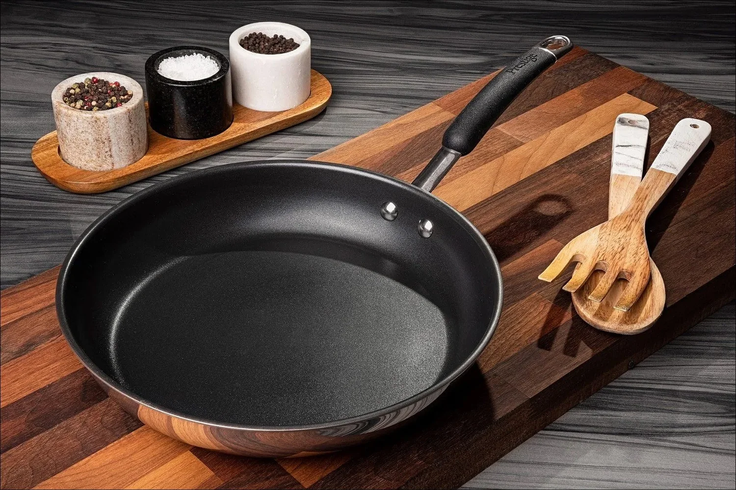 Prestige stainless steel frying pan on wooden board