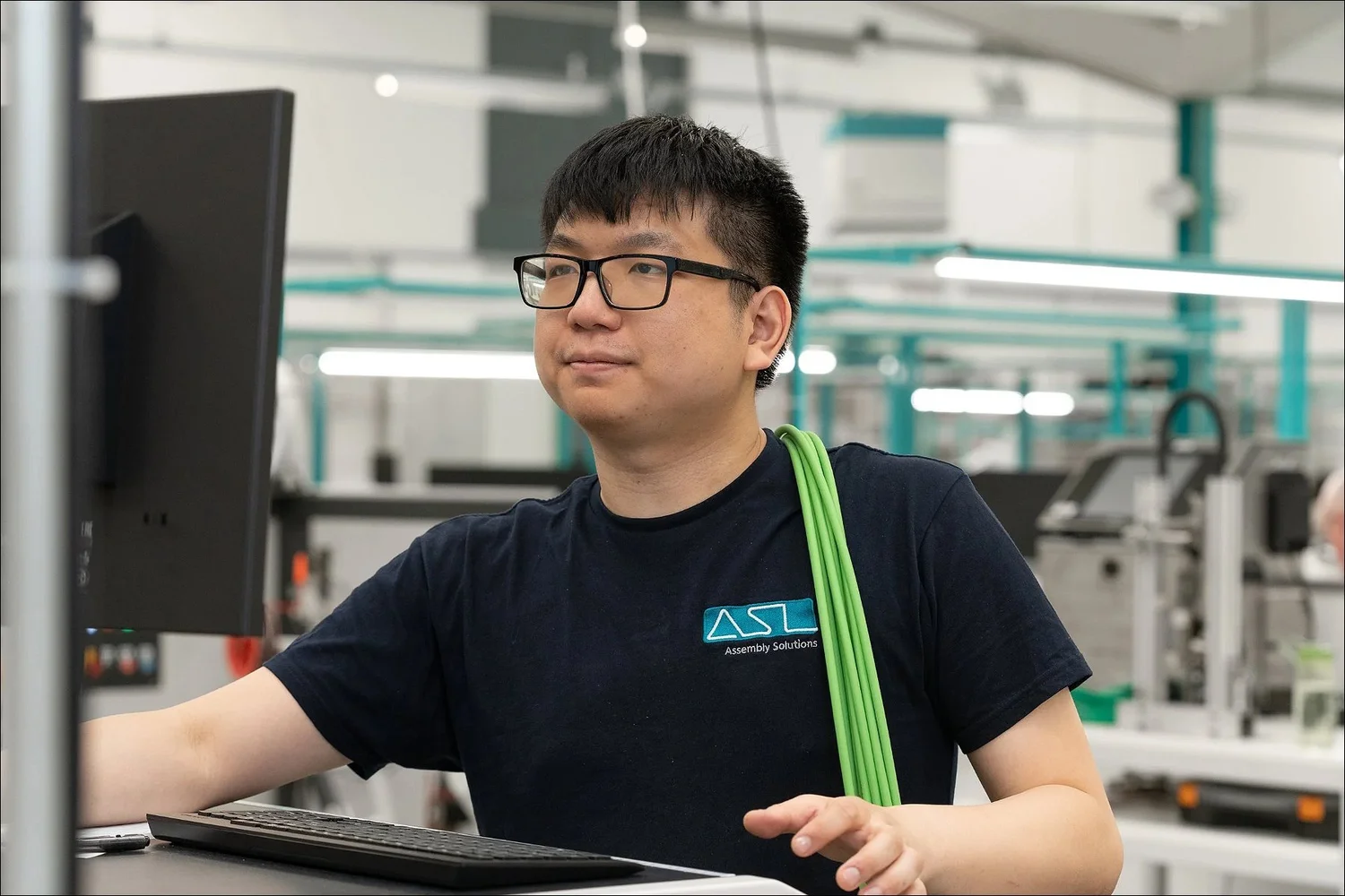 Electronics manufacturing worker asl solutions green wire bundle