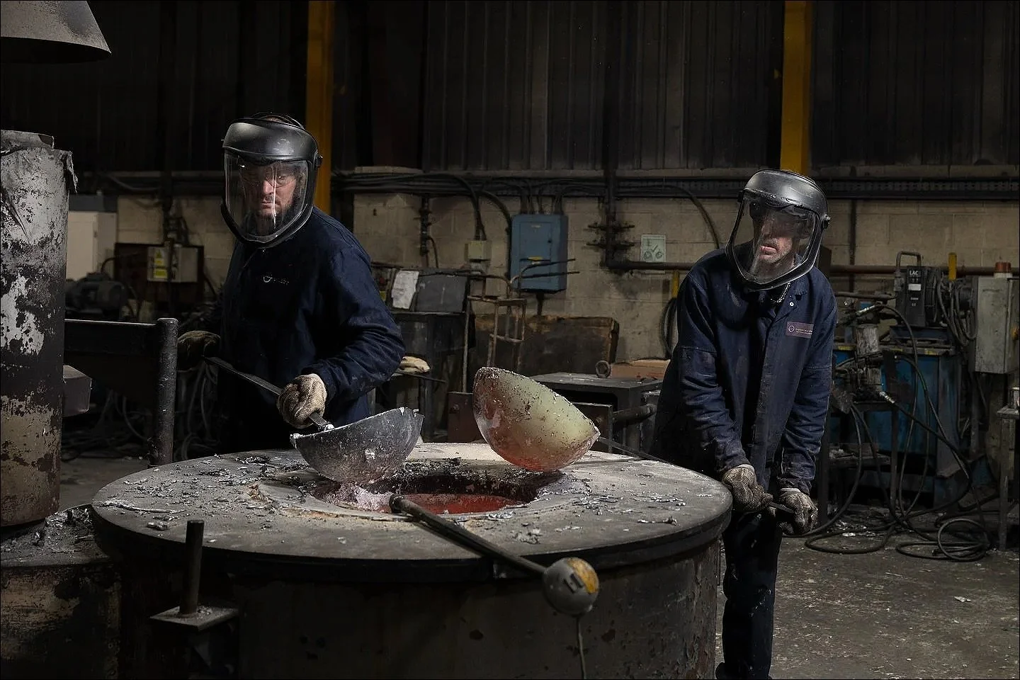 Foundry workers crucible molten metal accrington