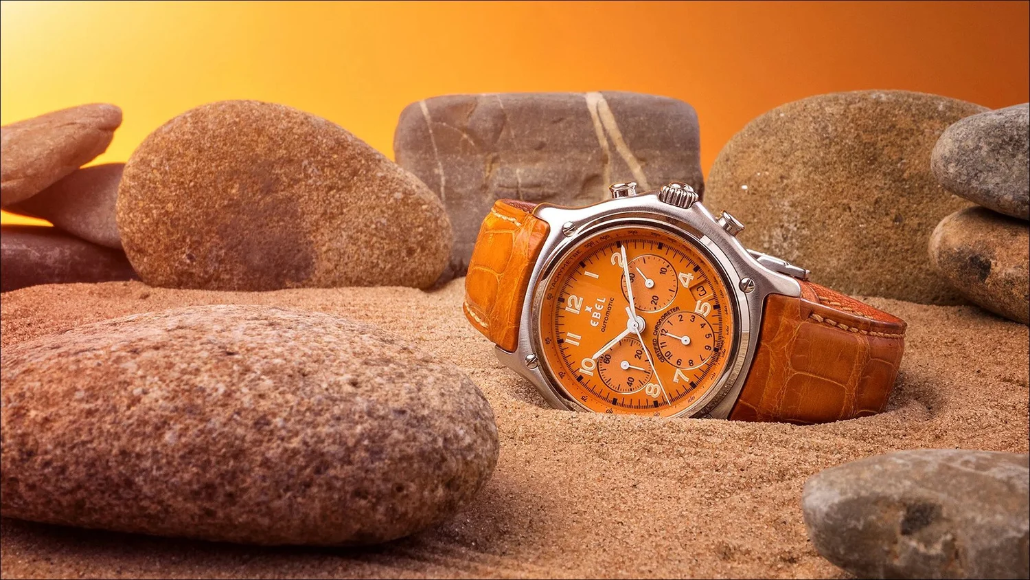 Orange leather strap ebel chronograph on sand