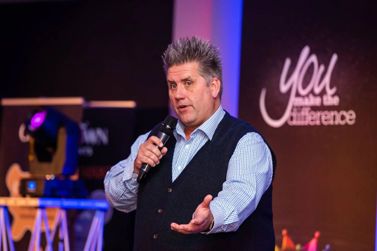 Corporate event photography with stage lighting and audience