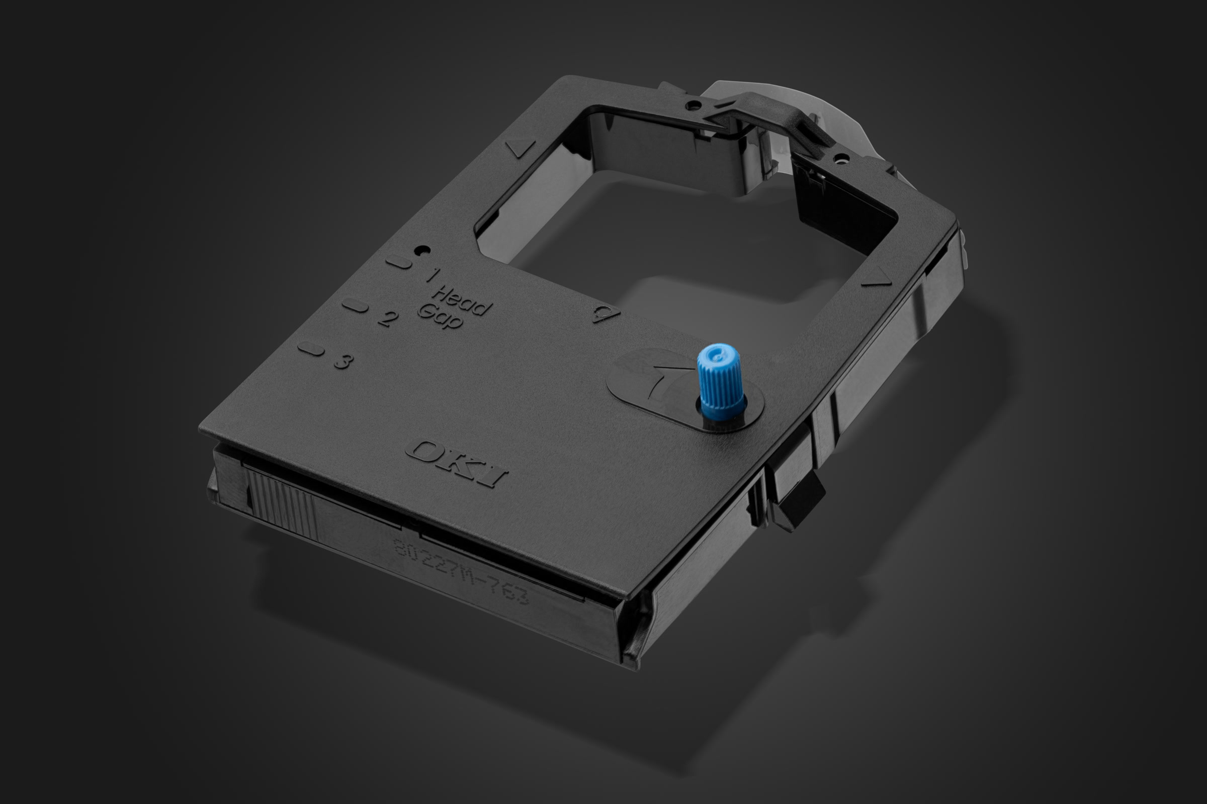 Black moulded electronics housing with a blue fitting photographed in the studio