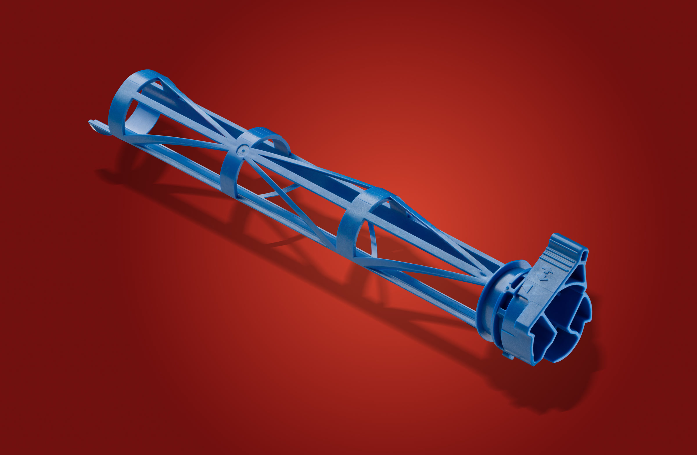 Long blue injection-moulded plastic component photographed in the studio