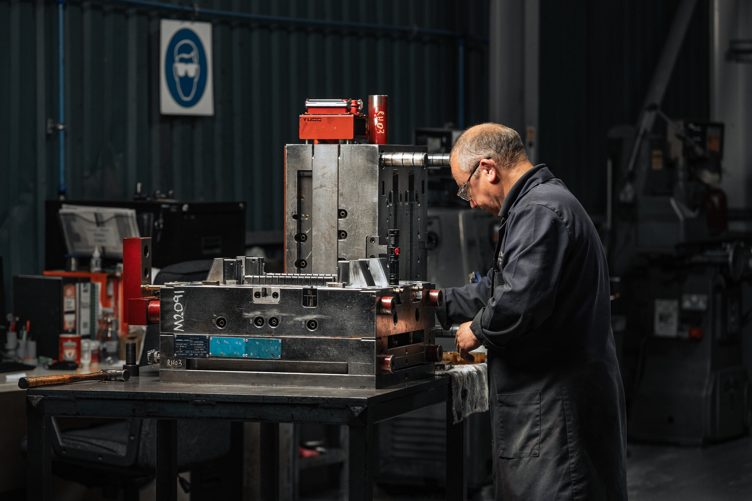 AC Plastics toolmaker working beside a large metal mould tool