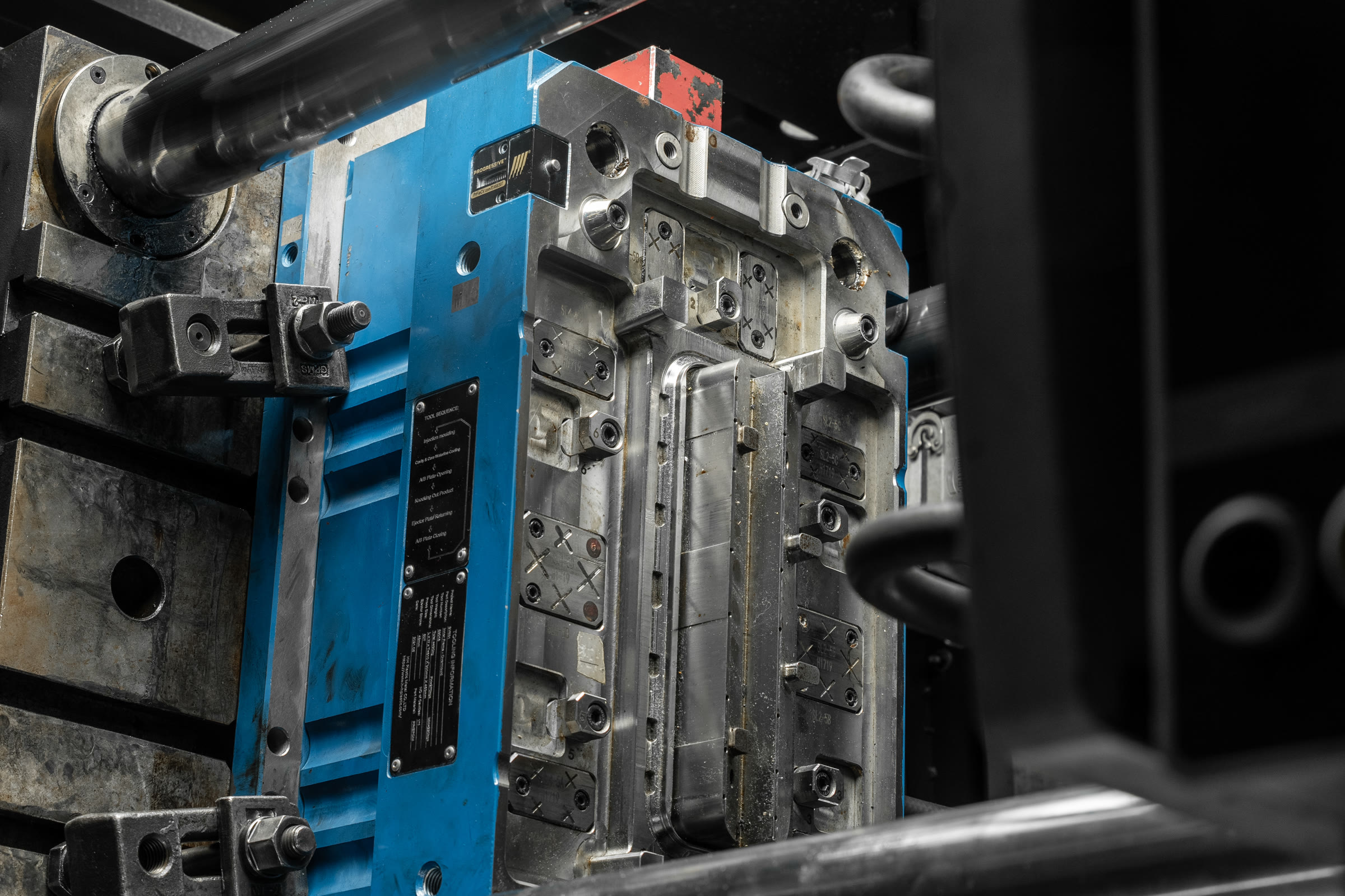 Blue-framed injection mould tool installed in production machinery