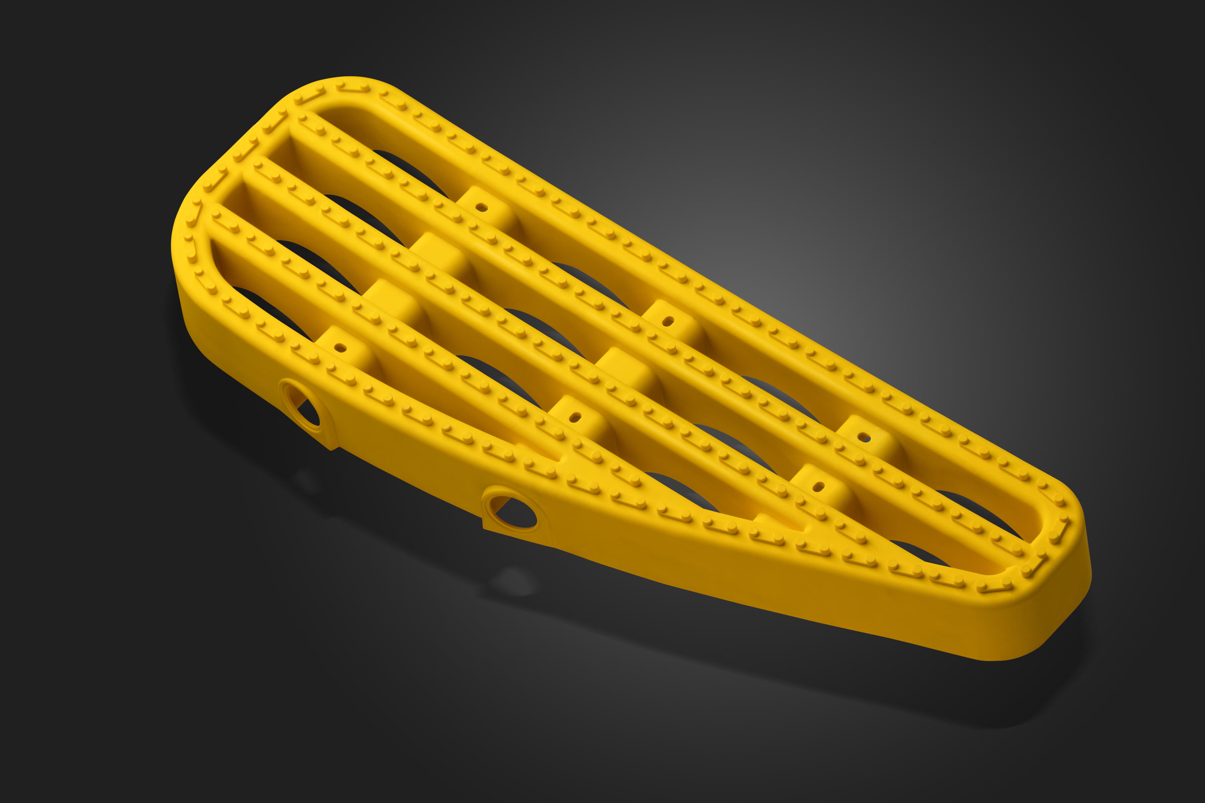 Alternate view of a yellow moulded plastic component in the studio