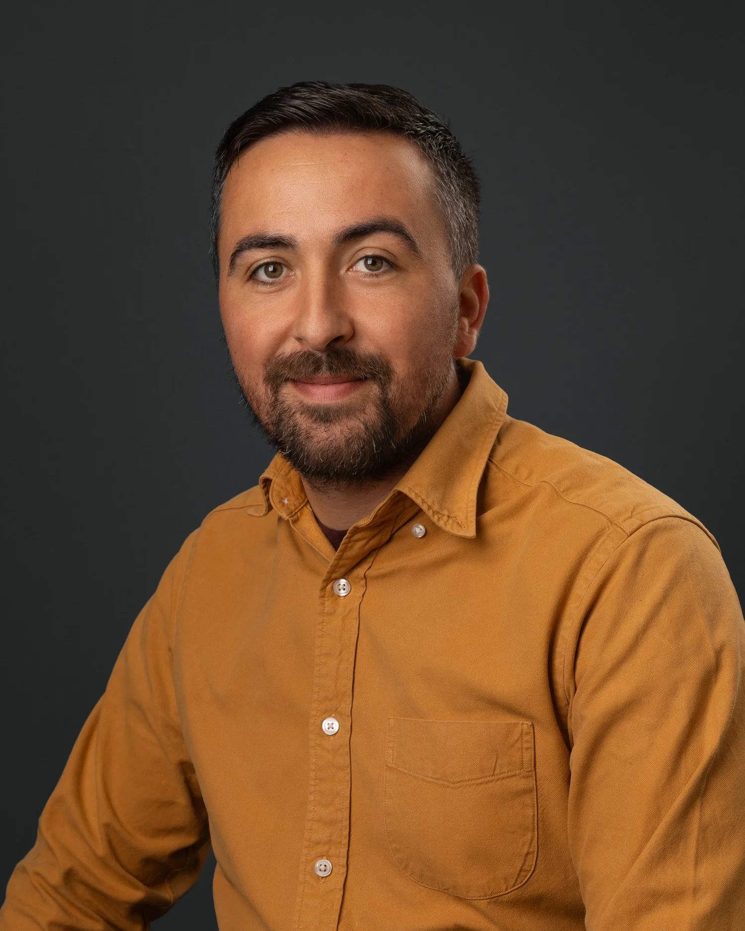 Professional corporate headshot on a clean studio background