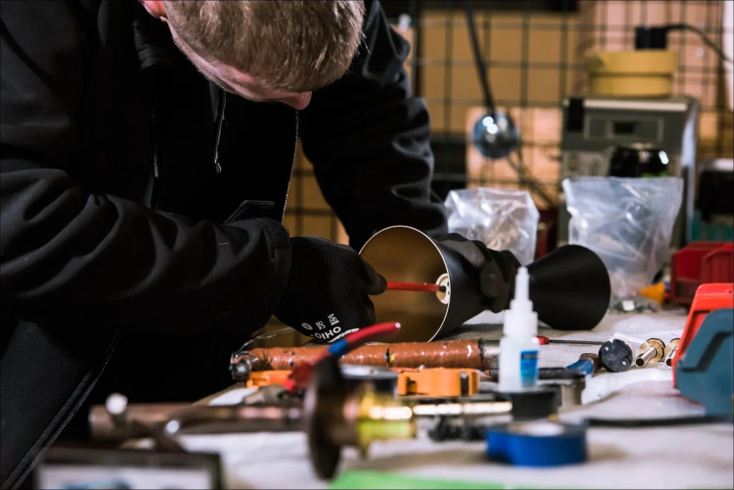 Technician working on a gold interior fixture in a North West manufacturing facility
