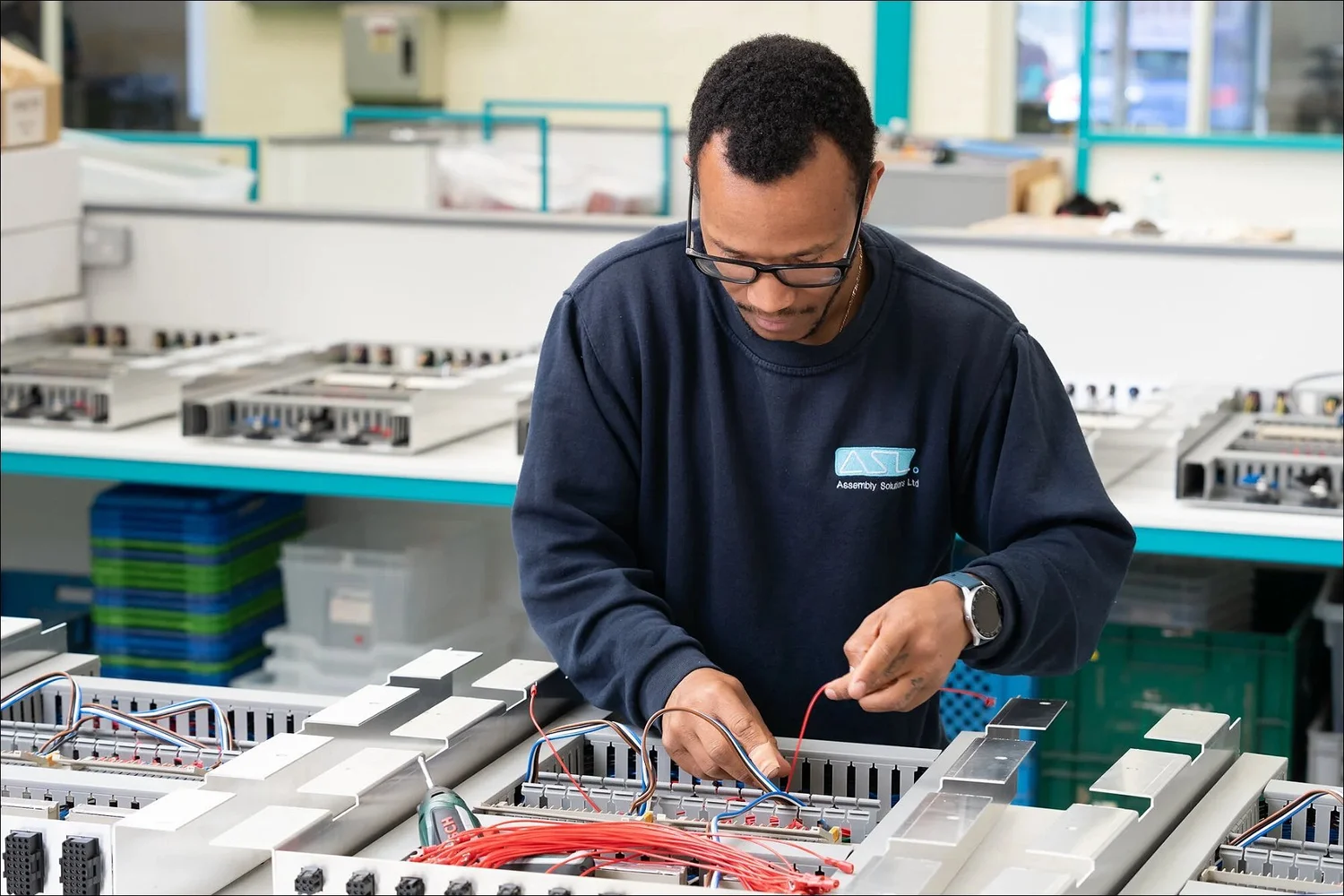 Assembly worker connecting red wires bosch tool