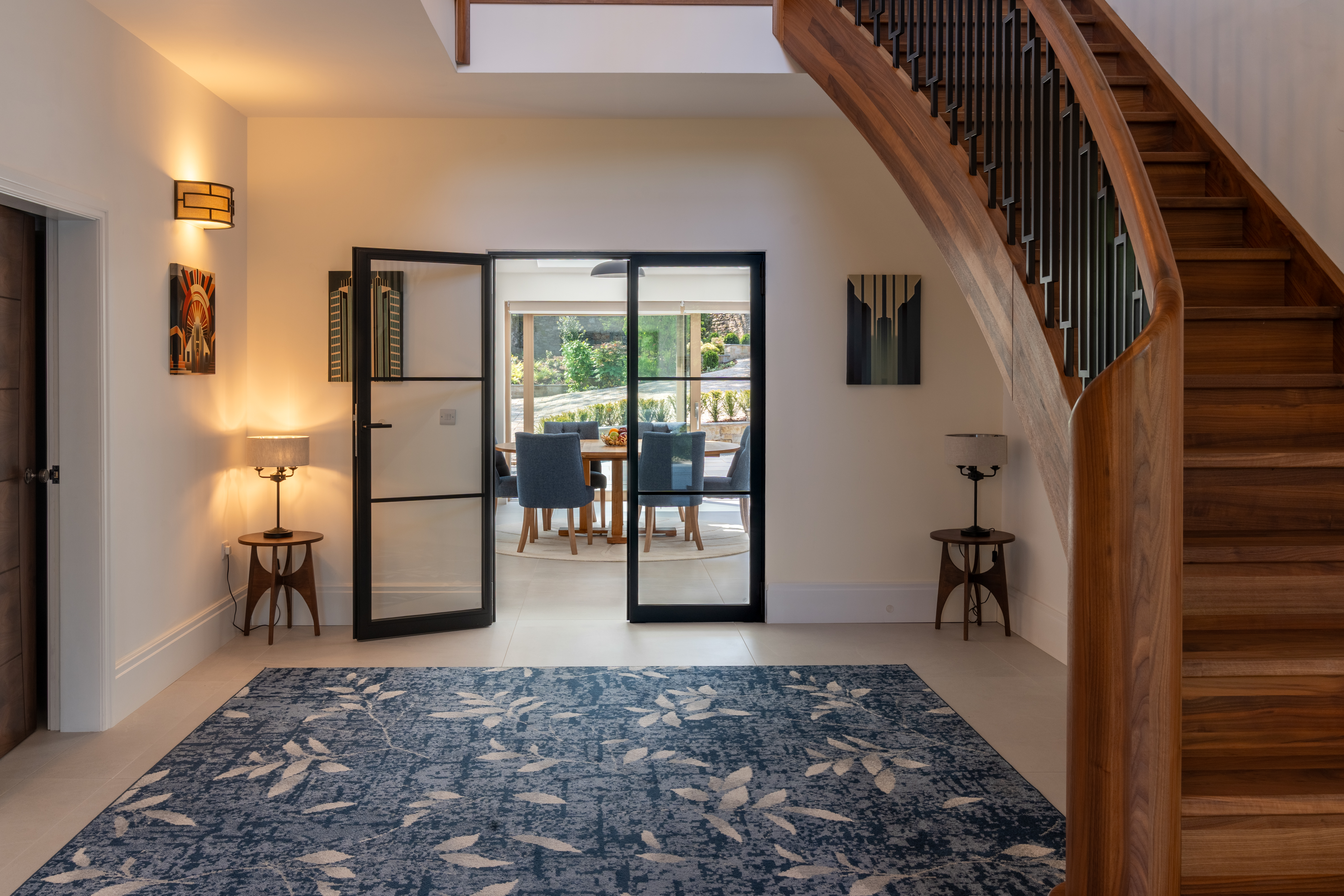 Interior with a curved Crittall-style glazed partition leading through to the dining area